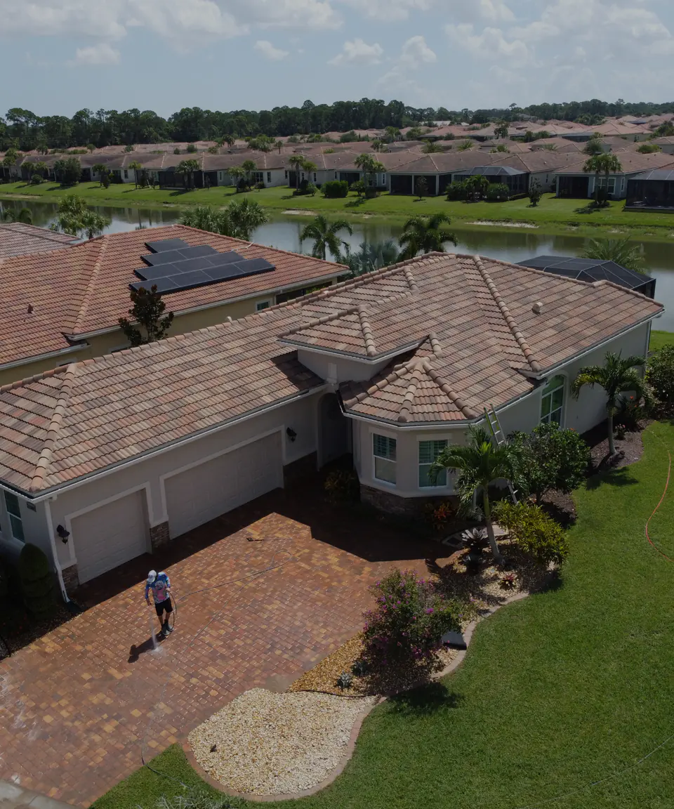 Concrete tile roofs and South Florida landscaping viewed during exterior service work